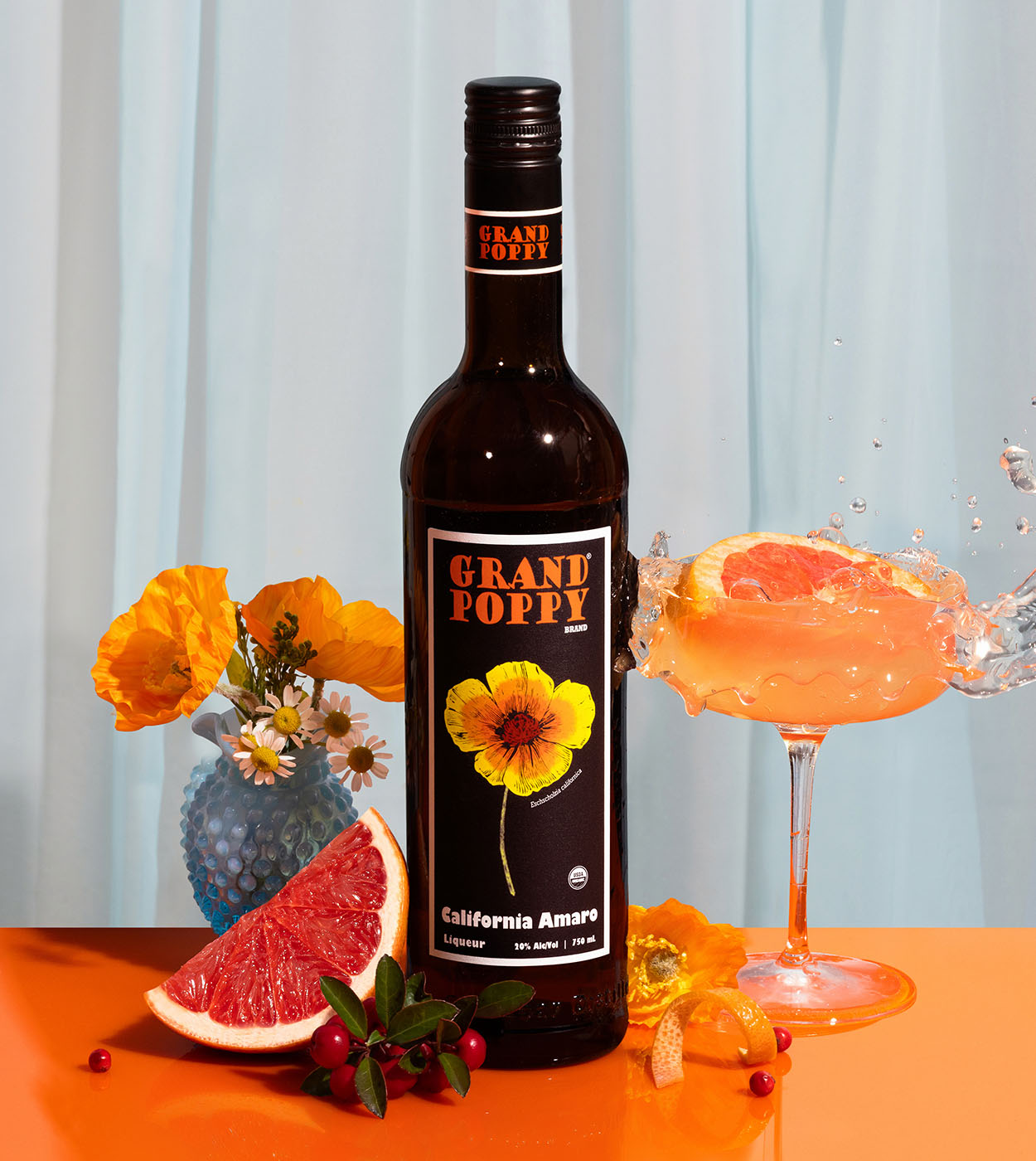 Grand Poppy Bottle with cocktail splashing