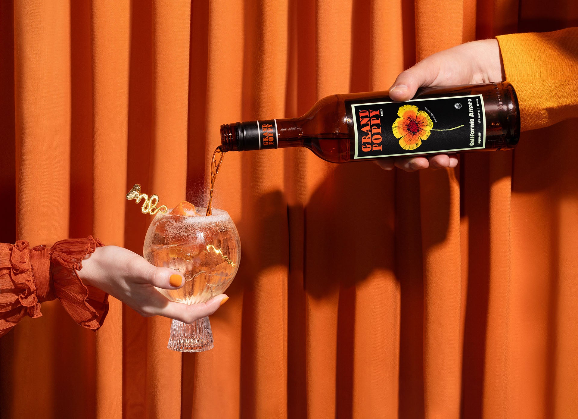 Grand Poppy California Amaro bottle pouring a spritz